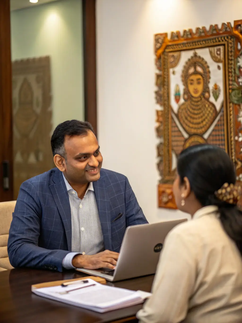 A professional in a modern office setting in Bangalore, India, confidently presenting a business strategy to colleagues.